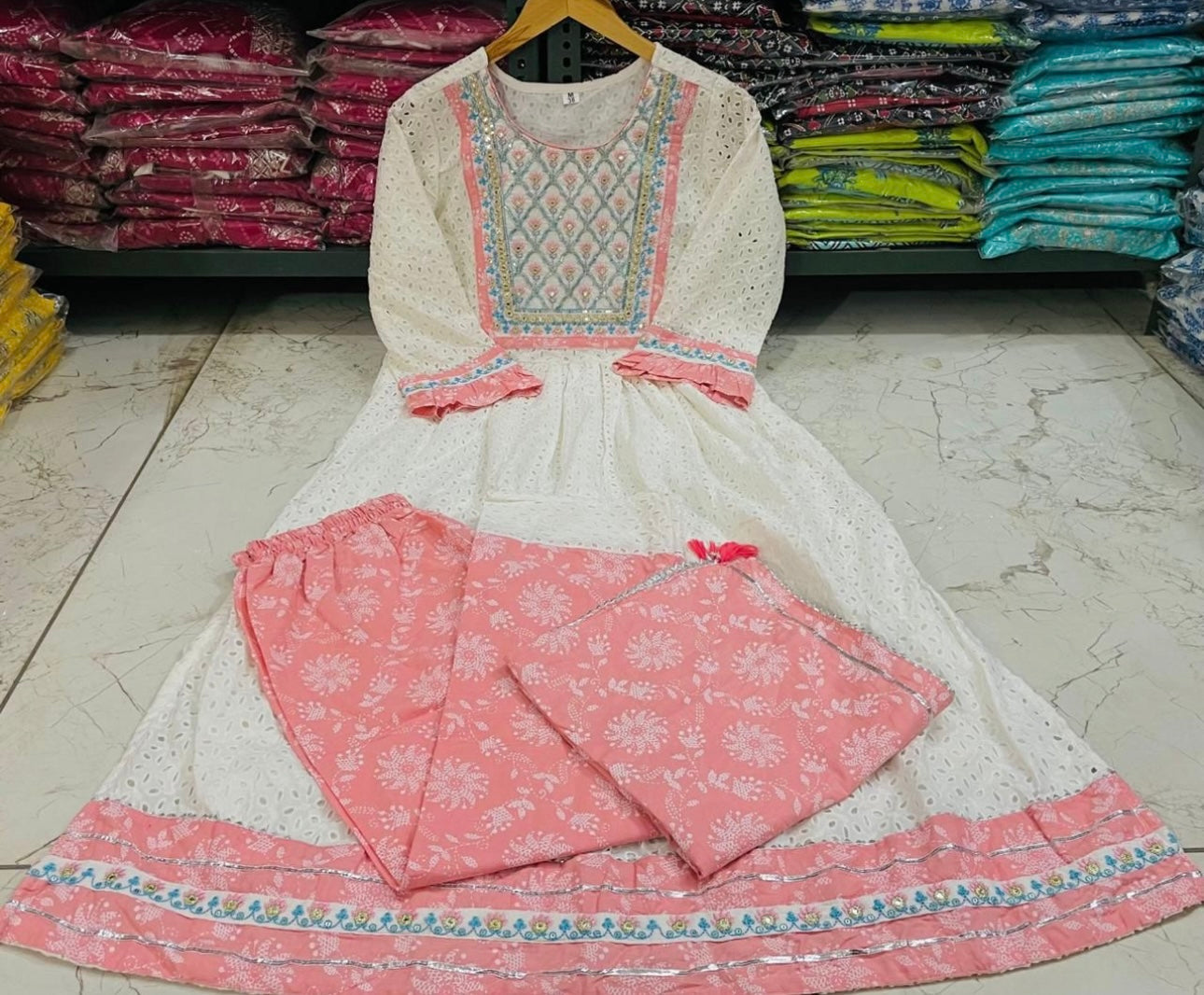 A Cotton Nyra cut kurti with lining embroidery & gota lace.