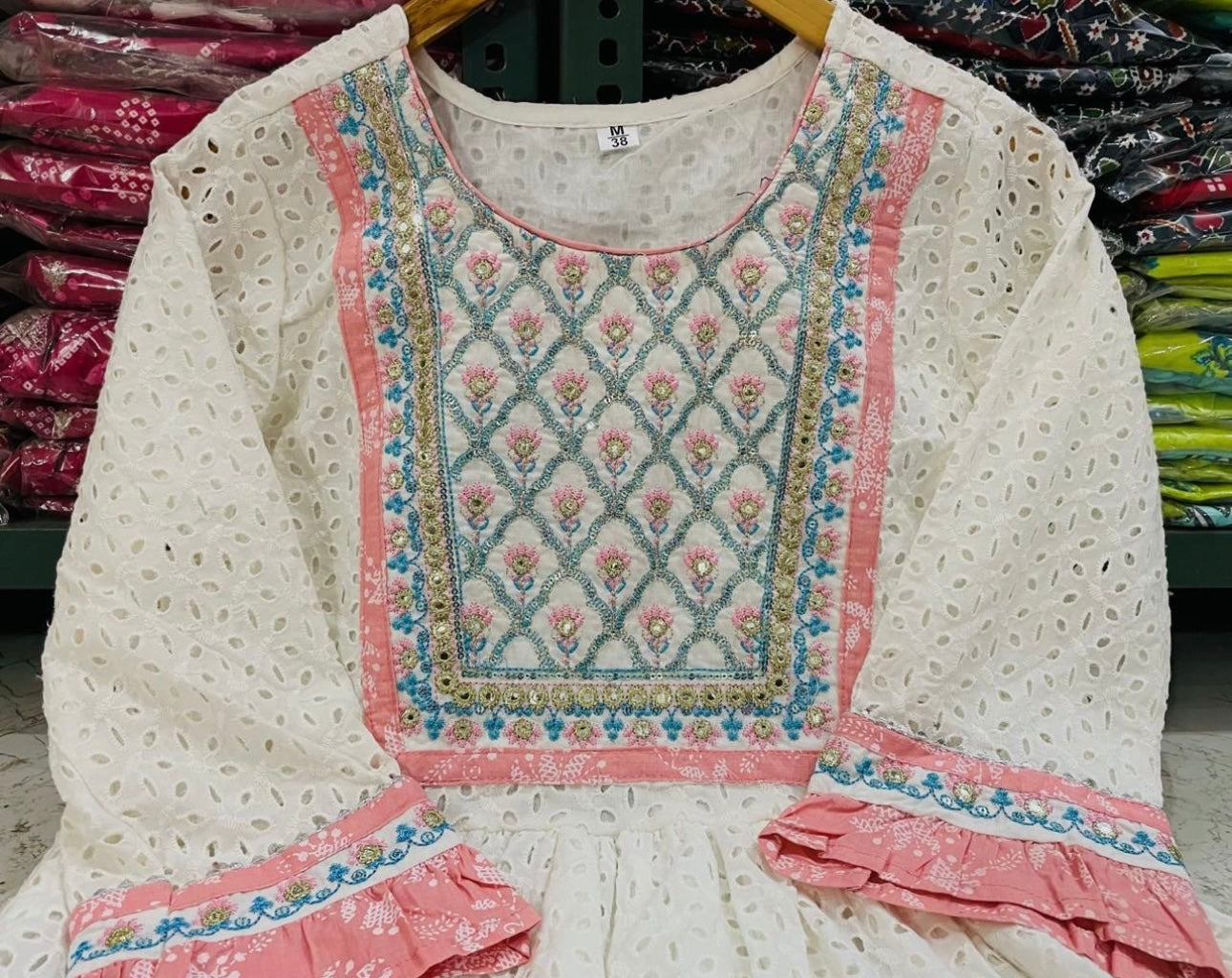 A Cotton Nyra cut kurti with lining embroidery & gota lace.